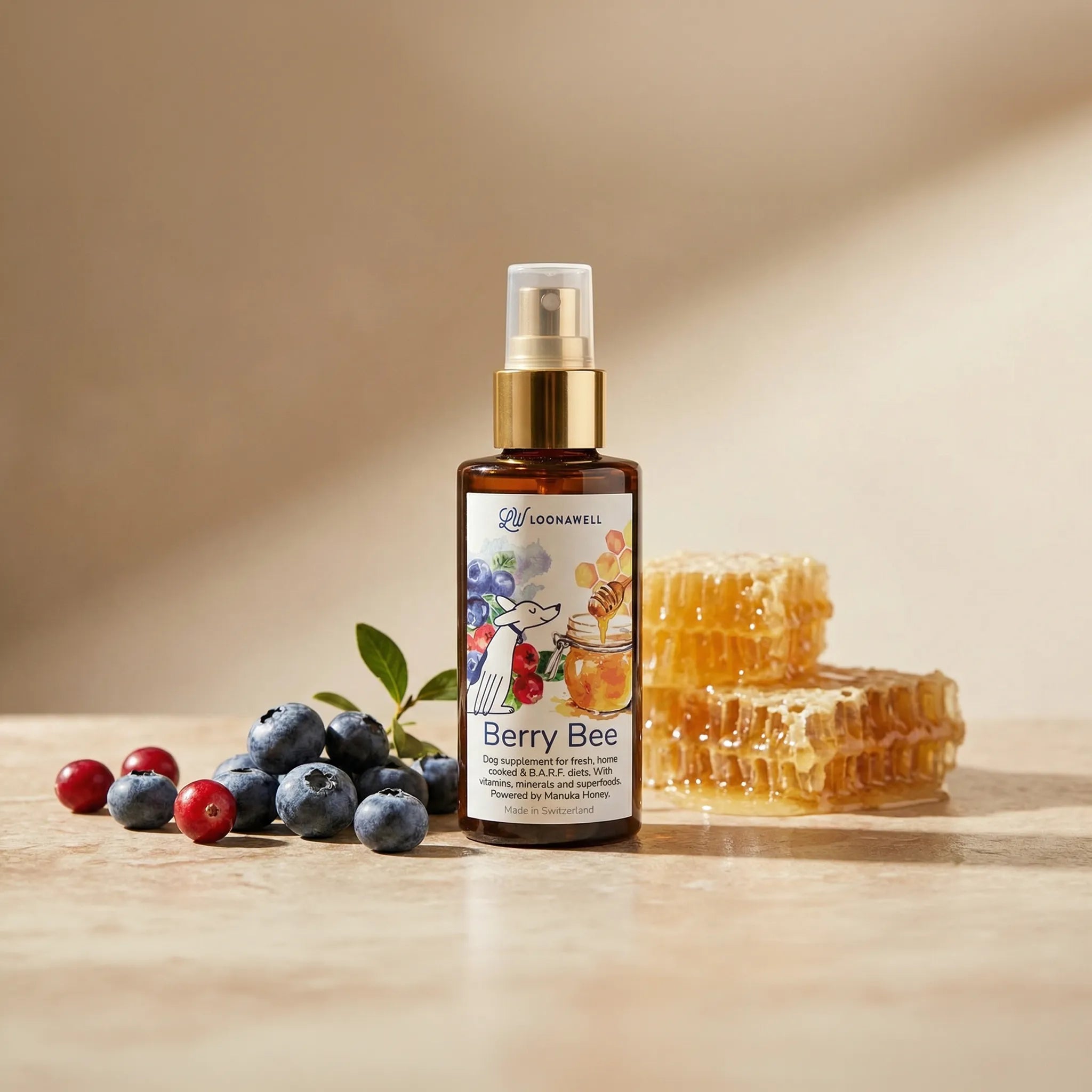 A bottle of Loonawell Berry Bee dog supplement surrounded by fresh blueberries, cranberries, and raw honeycomb.